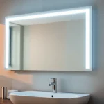 Reflective mirror and LED lights enhance a stylish modern bathroom ambiance.