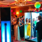 Guests enjoying a photo booth rental at a vibrant event with fun props.